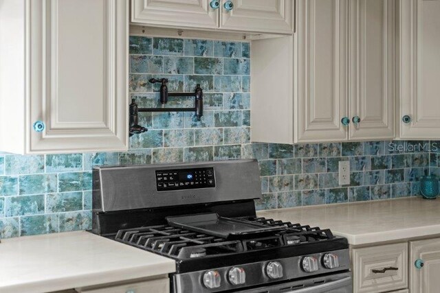 kitchen featuring tasteful backsplash and stainless steel range with gas stovetop