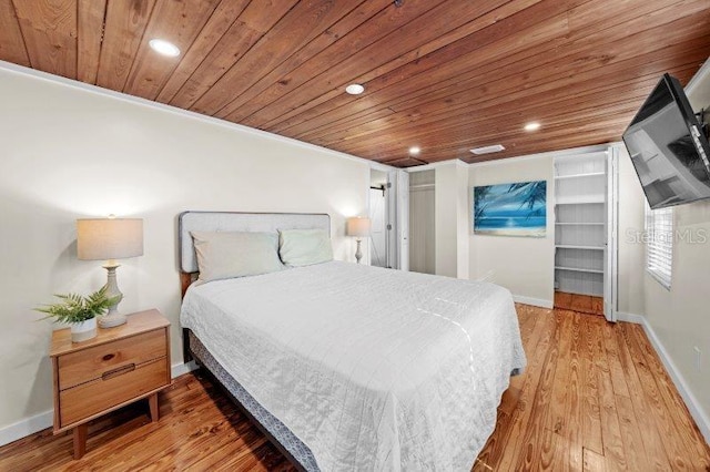 bedroom with hardwood / wood-style floors, wood ceiling, and ornamental molding