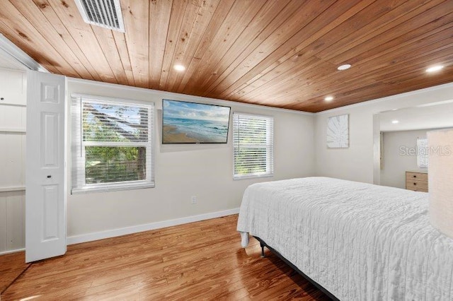 bedroom with hardwood / wood-style flooring, multiple windows, and wooden ceiling