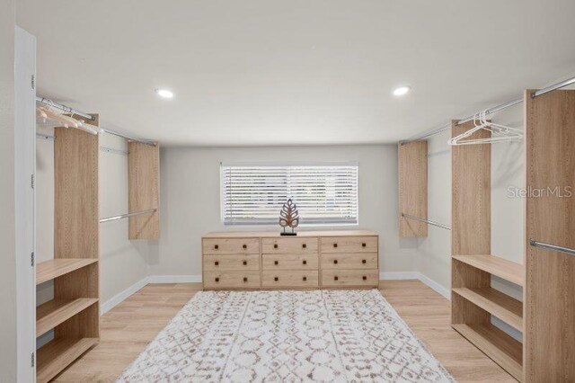 walk in closet featuring light hardwood / wood-style flooring