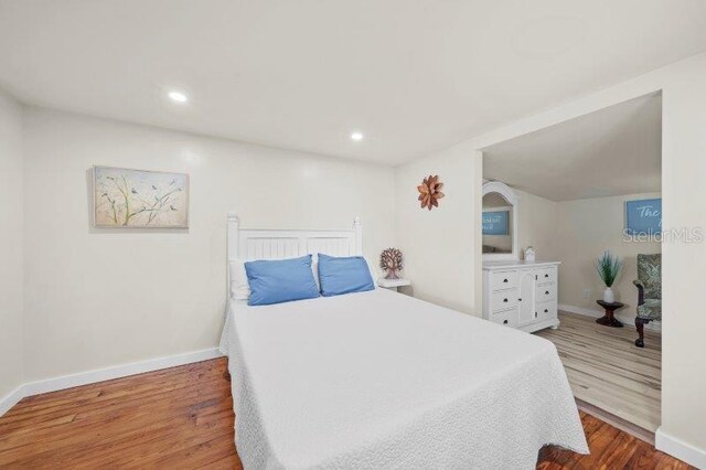 bedroom with hardwood / wood-style flooring