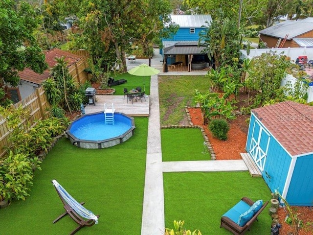 view of pool featuring area for grilling and a wooden deck