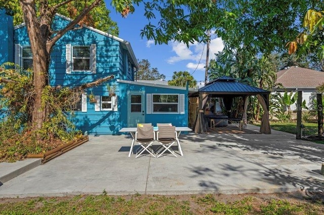 rear view of house with a gazebo and a patio area