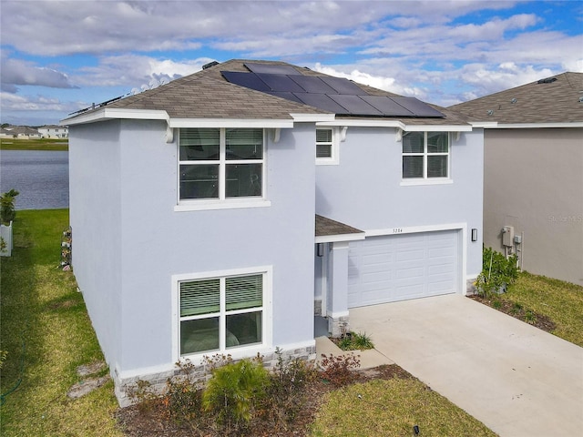 exterior space with a garage and solar panels