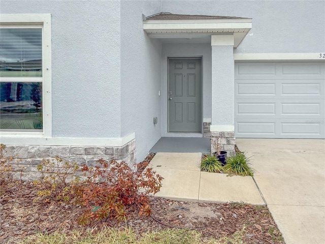 doorway to property with a garage