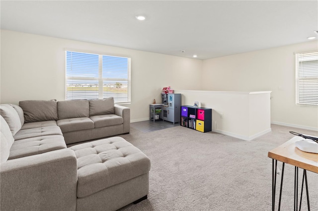 living room featuring carpet flooring and a healthy amount of sunlight