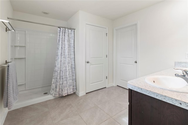 bathroom with a shower with curtain, tile patterned flooring, and vanity