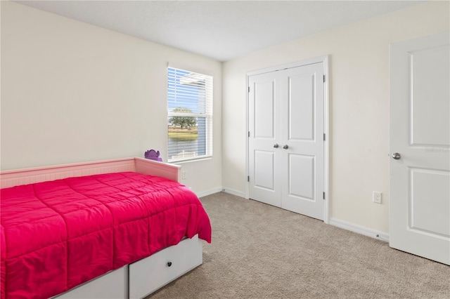 carpeted bedroom with a closet