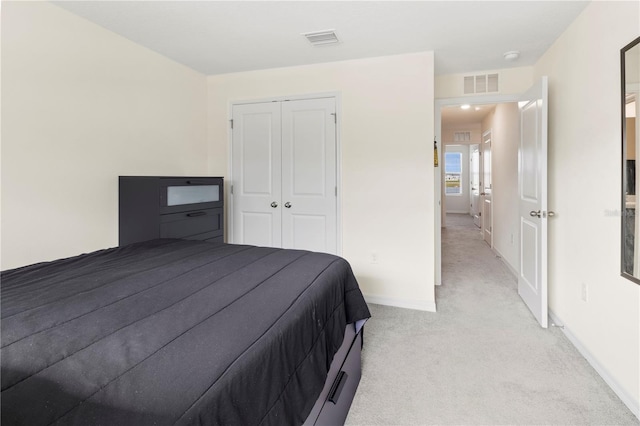 bedroom with light carpet and a closet