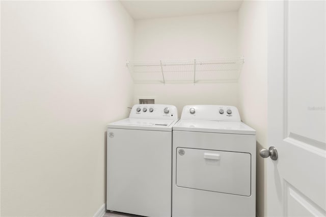 clothes washing area with washer and dryer