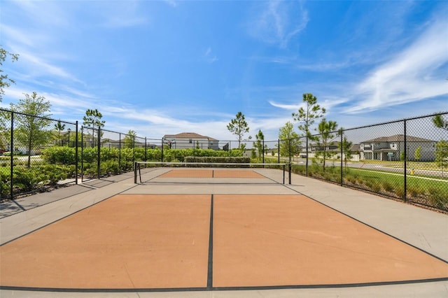 view of home's community with tennis court