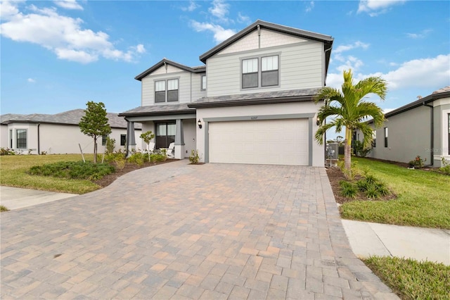 view of front of house featuring a garage and a front lawn