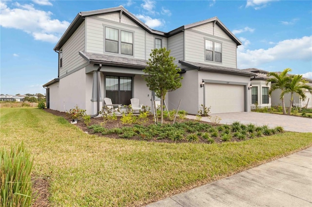 view of front of house with a garage and a front lawn