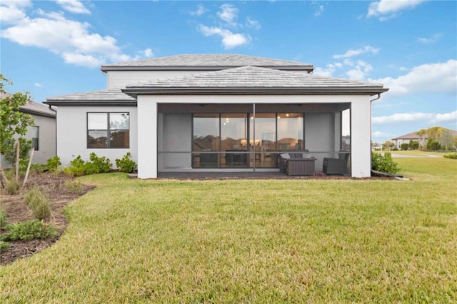 back of property with a yard and an outdoor hangout area