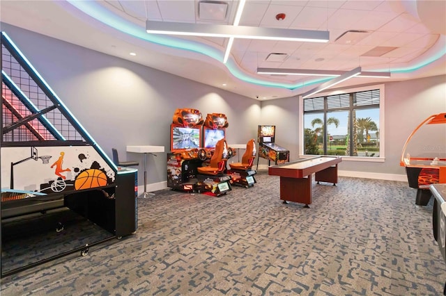 rec room with a tray ceiling and carpet floors