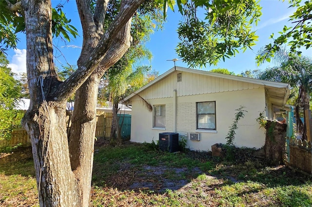 view of side of home with central air condition unit