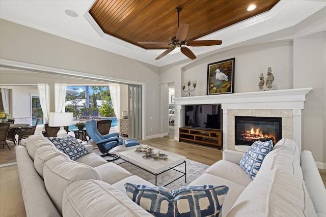 living room with light wood-type flooring, crown molding, ceiling fan, and wooden ceiling