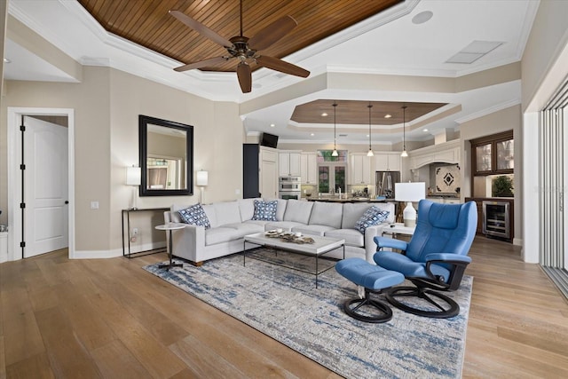 living room featuring a raised ceiling, wood ceiling, crown molding, and light hardwood / wood-style flooring