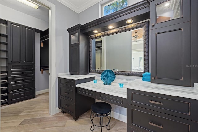 bathroom featuring vanity, wood-type flooring, and crown molding