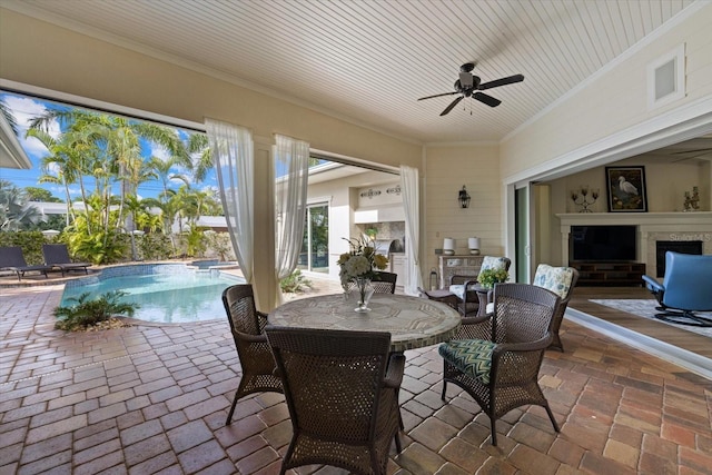 view of patio / terrace featuring ceiling fan and exterior fireplace