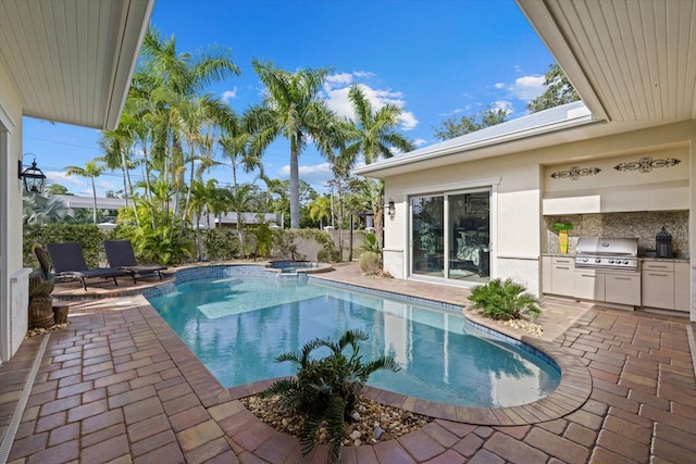 view of swimming pool featuring an in ground hot tub, a patio, and area for grilling