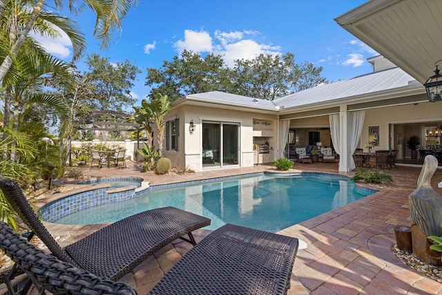 view of swimming pool featuring an in ground hot tub, a patio, and area for grilling