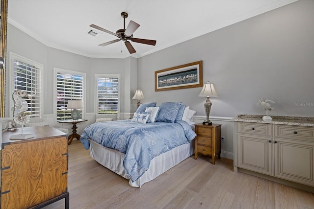 bedroom with ceiling fan, ornamental molding, and light hardwood / wood-style flooring