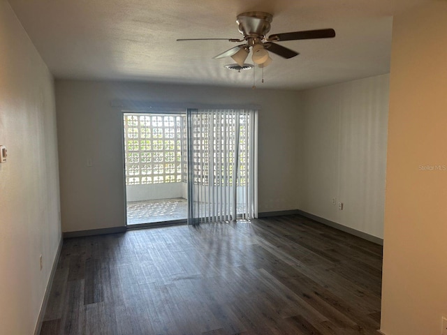 spare room featuring ceiling fan and dark hardwood / wood-style floors