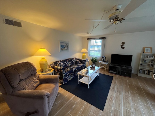 living room with hardwood / wood-style flooring and ceiling fan