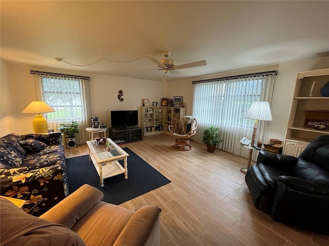 living room with ceiling fan and light wood-type flooring