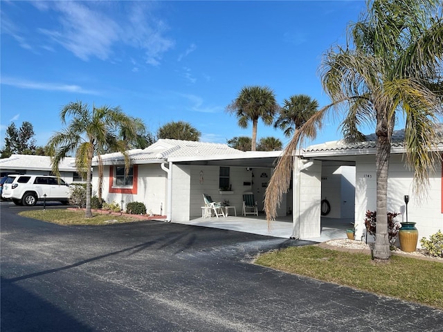 ranch-style home featuring a carport