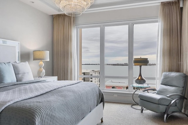 carpeted bedroom with a chandelier and a water view