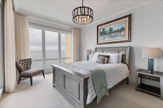 carpeted bedroom with crown molding, a water view, and a notable chandelier