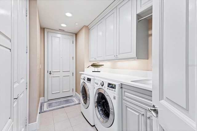 laundry area featuring cabinets, independent washer and dryer, sink, and light tile patterned flooring