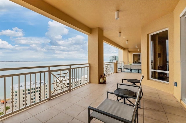 balcony with a water view and a beach view