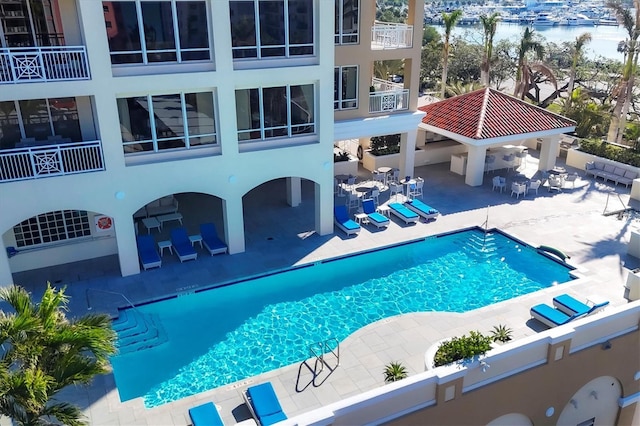 view of swimming pool with a gazebo, a water view, and a patio