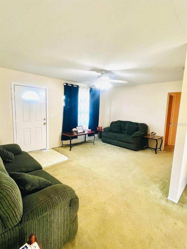 carpeted living room featuring ceiling fan