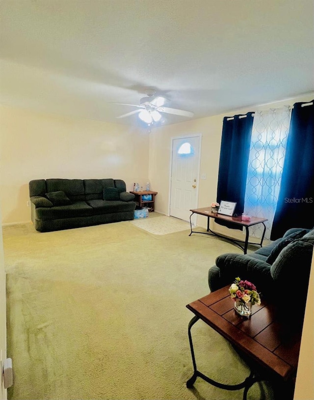 carpeted living room featuring ceiling fan