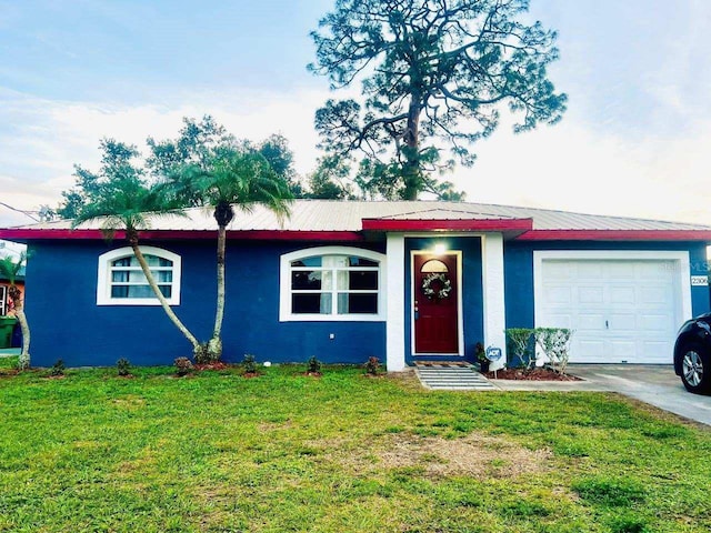 ranch-style house featuring a front lawn and a garage