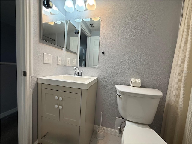 bathroom featuring vanity and toilet