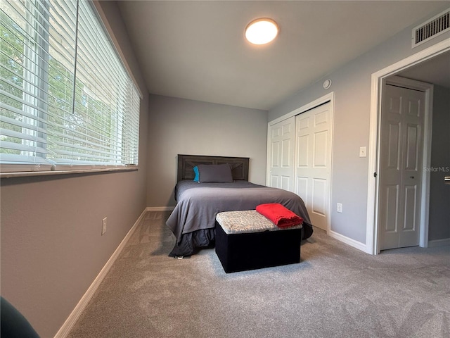 carpeted bedroom with a closet