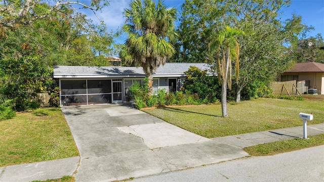 single story home featuring a carport and a front yard