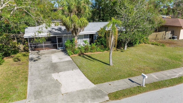 view of front of house with a front yard and a carport