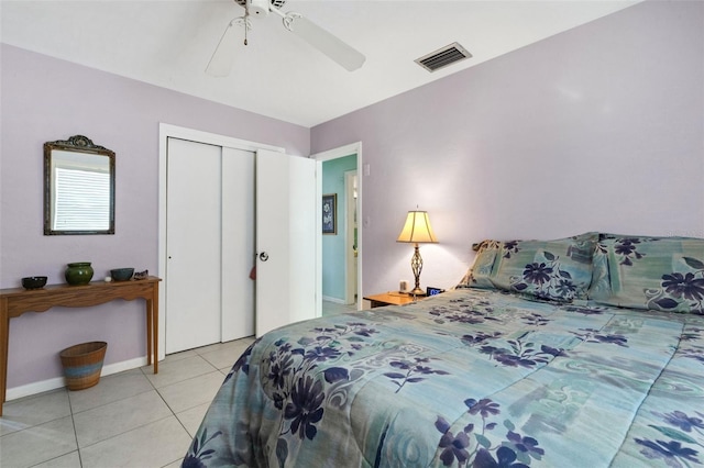 bedroom with light tile patterned flooring, a closet, and ceiling fan