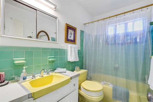 bathroom with walk in shower, toilet, vanity, and tile walls