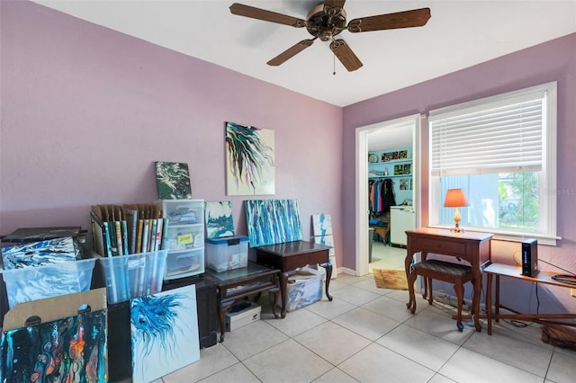 office space with light tile patterned floors and ceiling fan