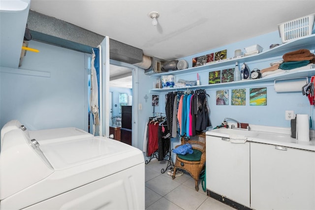 laundry area with light tile patterned flooring and separate washer and dryer