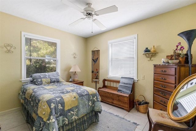 tiled bedroom featuring ceiling fan