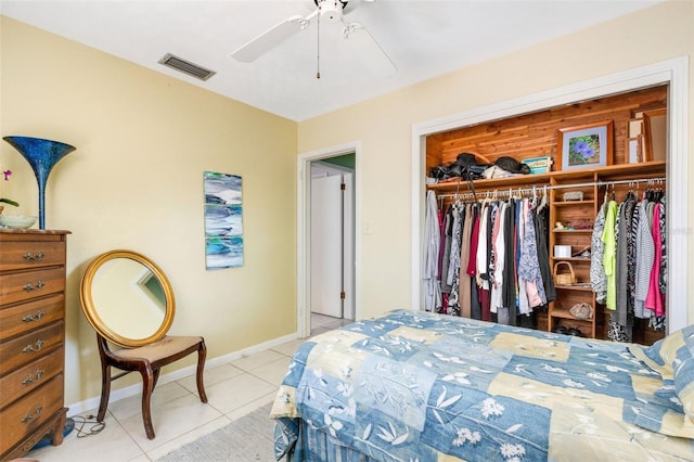 bedroom with a closet, light tile patterned floors, and ceiling fan