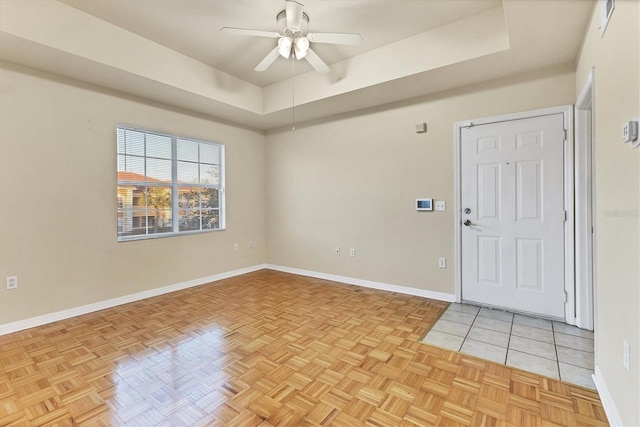 unfurnished room with ceiling fan and light parquet flooring